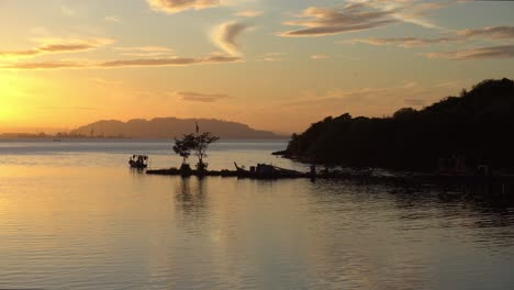 Silhouette-fishing-boat-departure-go-to-sea-in-sunrise